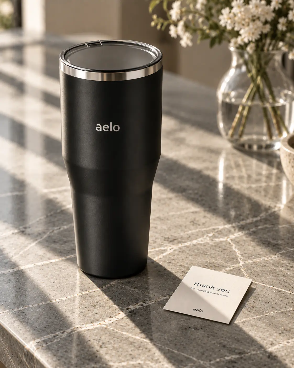 A black Aelo Ambassador tumbler beside a thank-you card.